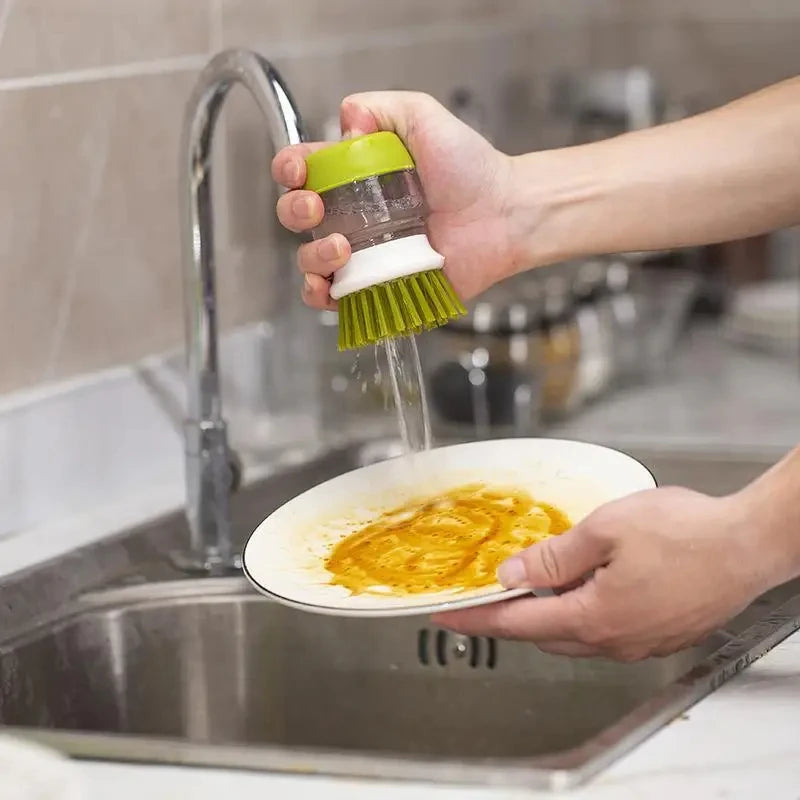 Soap-dispensing dish brush