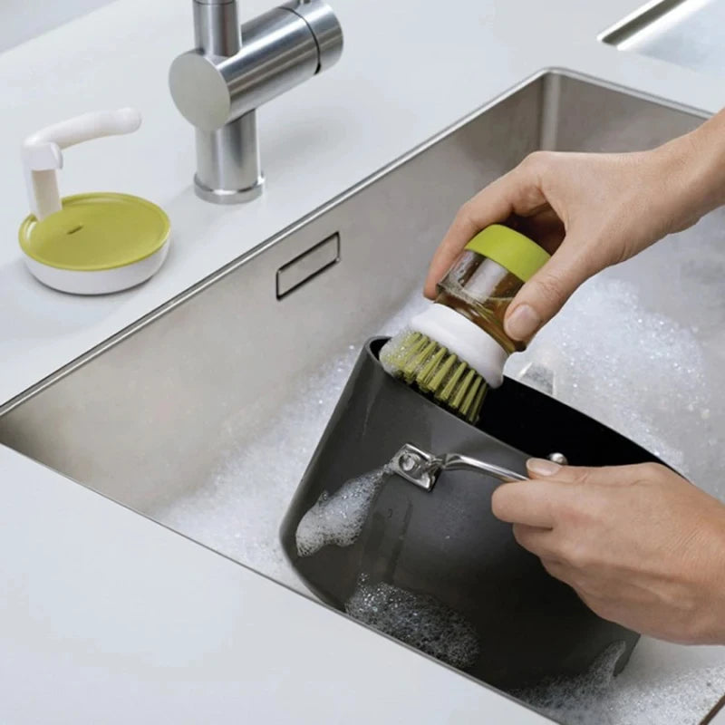 Soap-dispensing dish brush