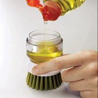 Soap-dispensing dish brush